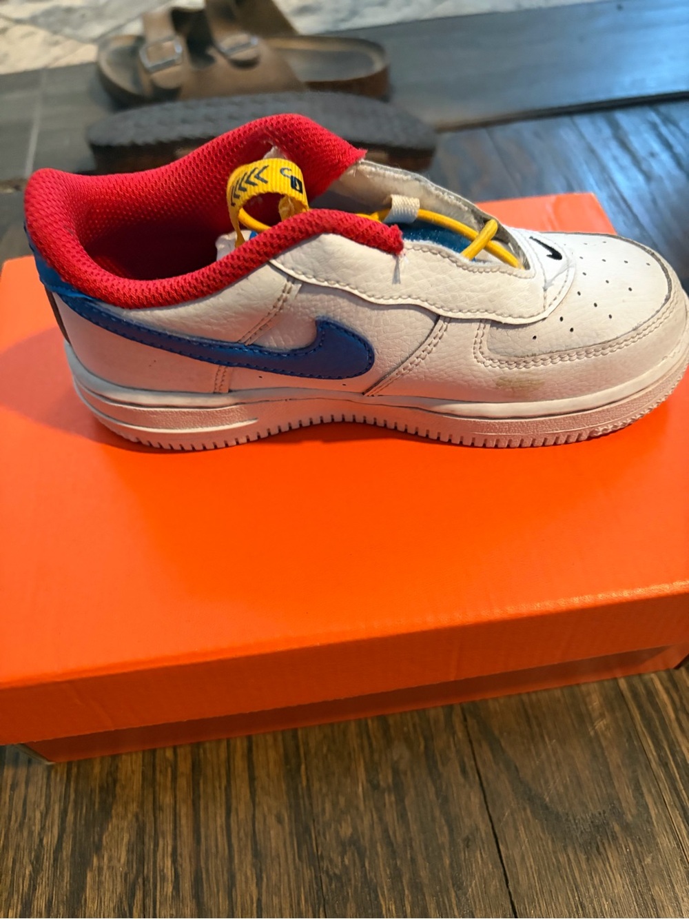 Nike Kids White Sneaker with Blue Swoosh and Red Lining